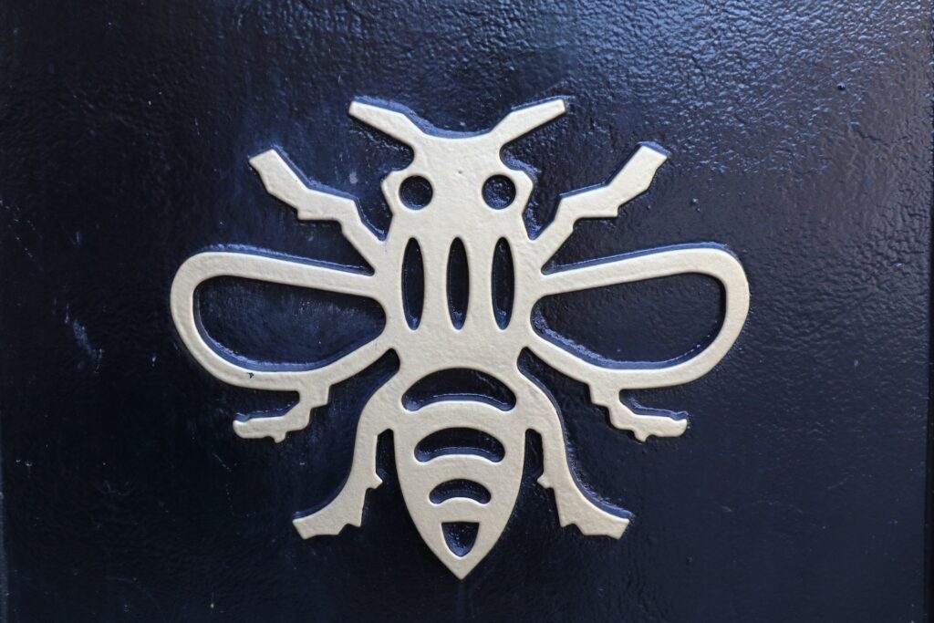 Manchester bee symbol gold on black